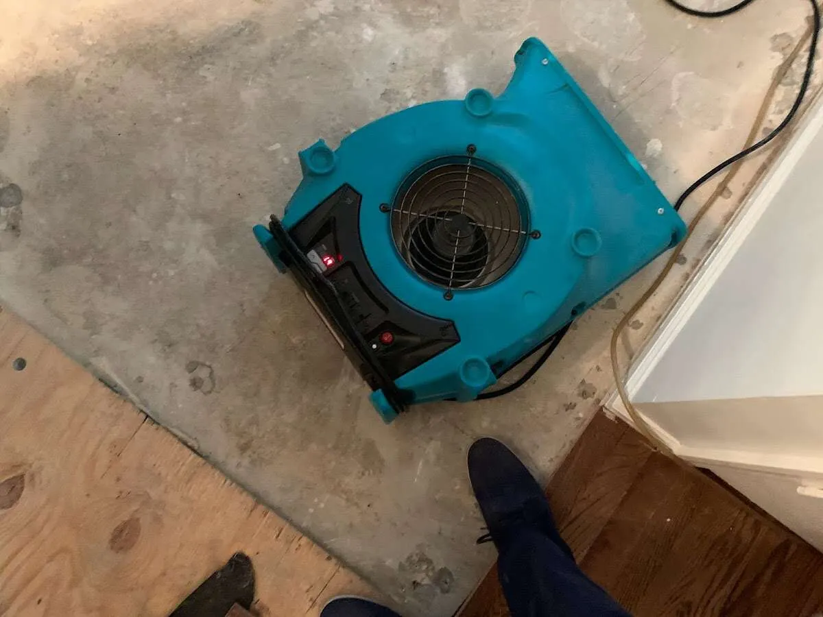 Air mover drying subfloor during Leak Detection & Repair in Katy